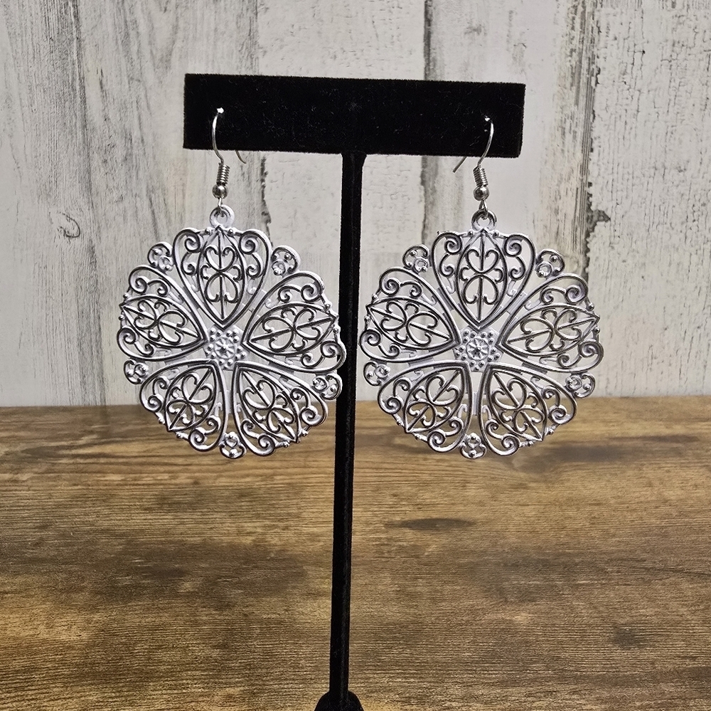 Large silver and white toned detailed hanging earrings
